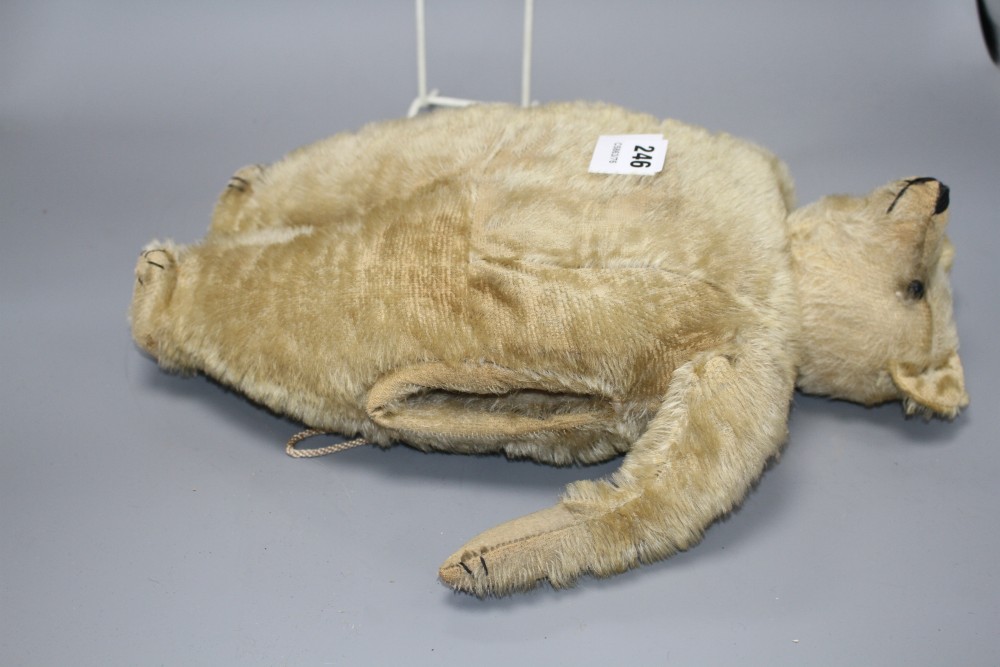 An early 20th century gold plush teddy bear hand warmer, with boot button eyes, length 40cm